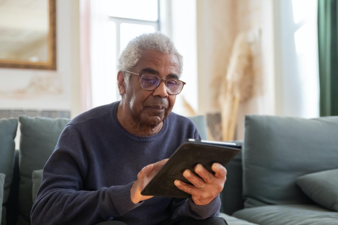 image shows elderly man accessing software